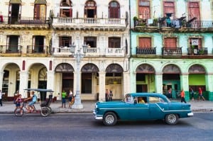 Havana, Cuba. Street scene with old car and worn out buildings.